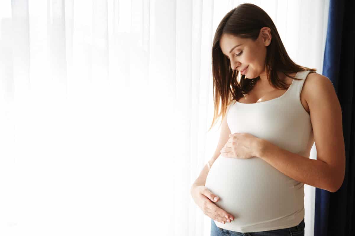 happy pregnant woman feel baby first kick